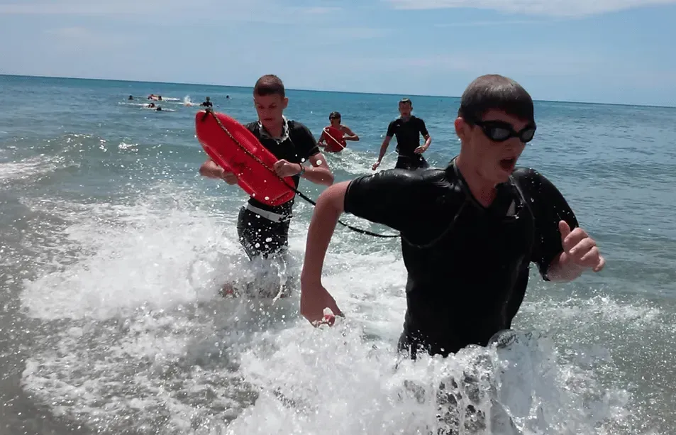 Students participating in a fun beach team-building activity with iReading Tutor