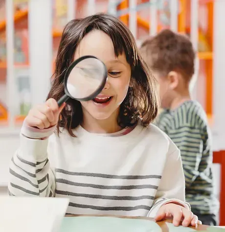 Child exploring and developing critical thinking skills through engaging learning activities at iReading Tutor