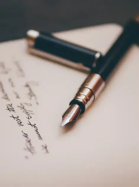 Fountain pen resting on paper, symbolizing writing practice, literacy skills, and language learning with iReading Tutor.