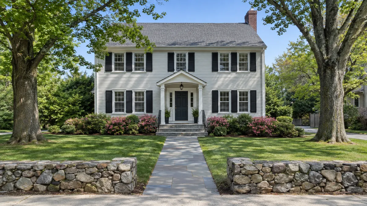 Tree-lined residential street in Waltham Massachusetts with well-maintained homes for sale in a competitive Greater Boston market