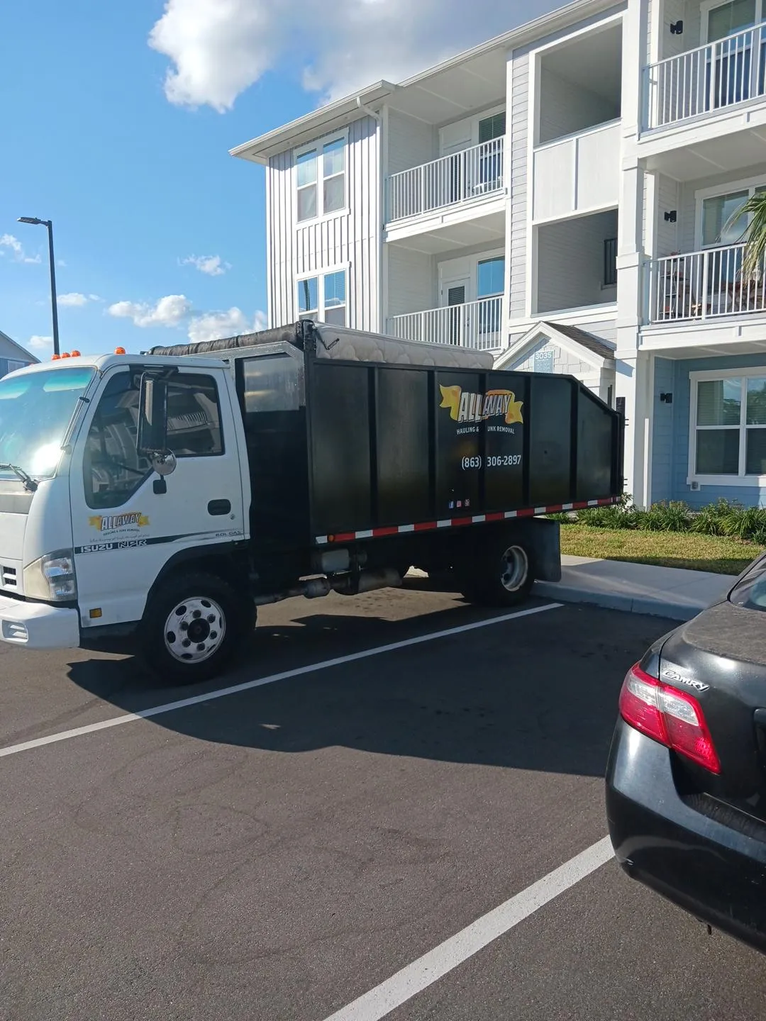 mattress in back of dump truck