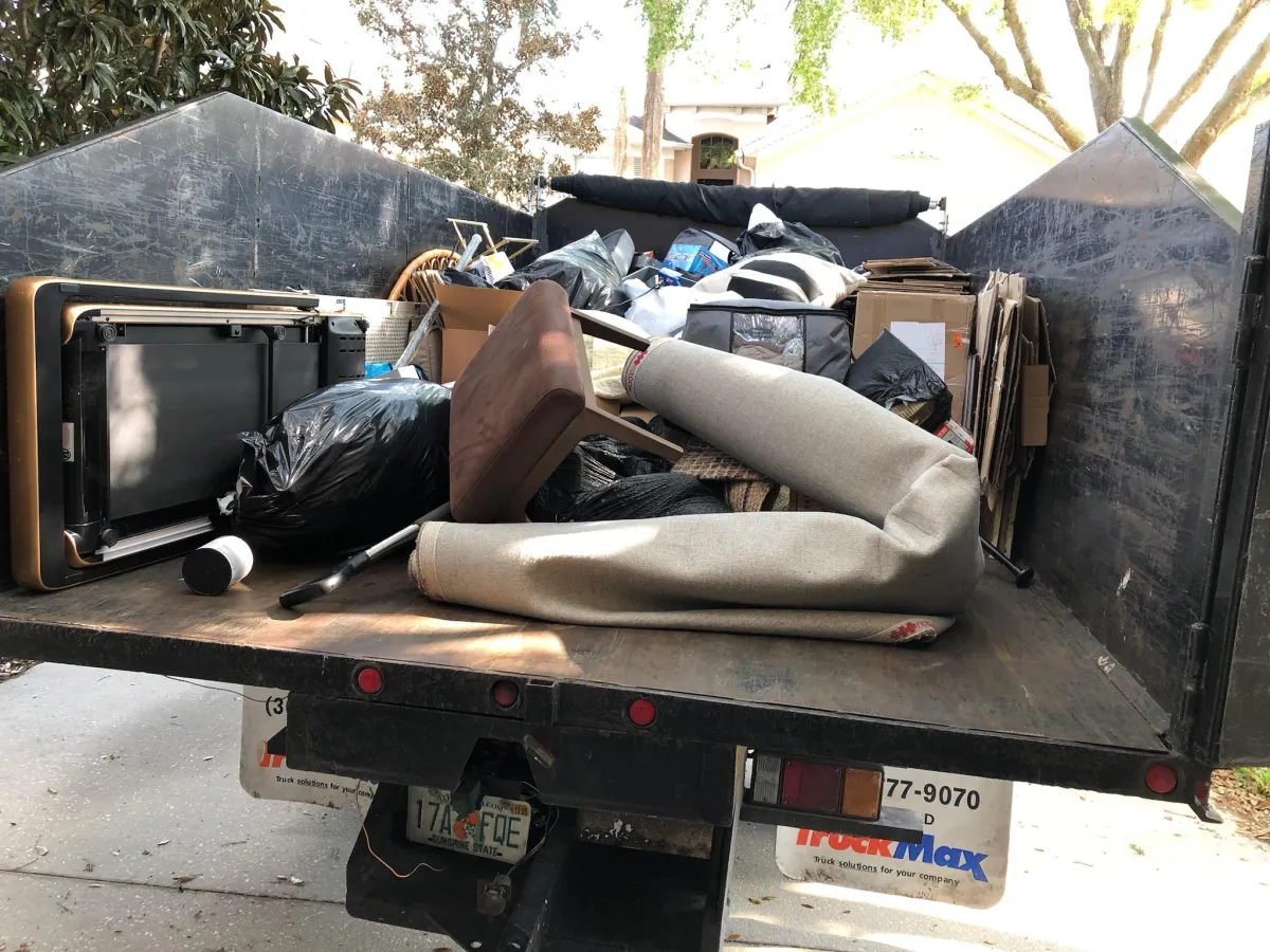 junk removal that includes mixed items of carpet, chair and tables