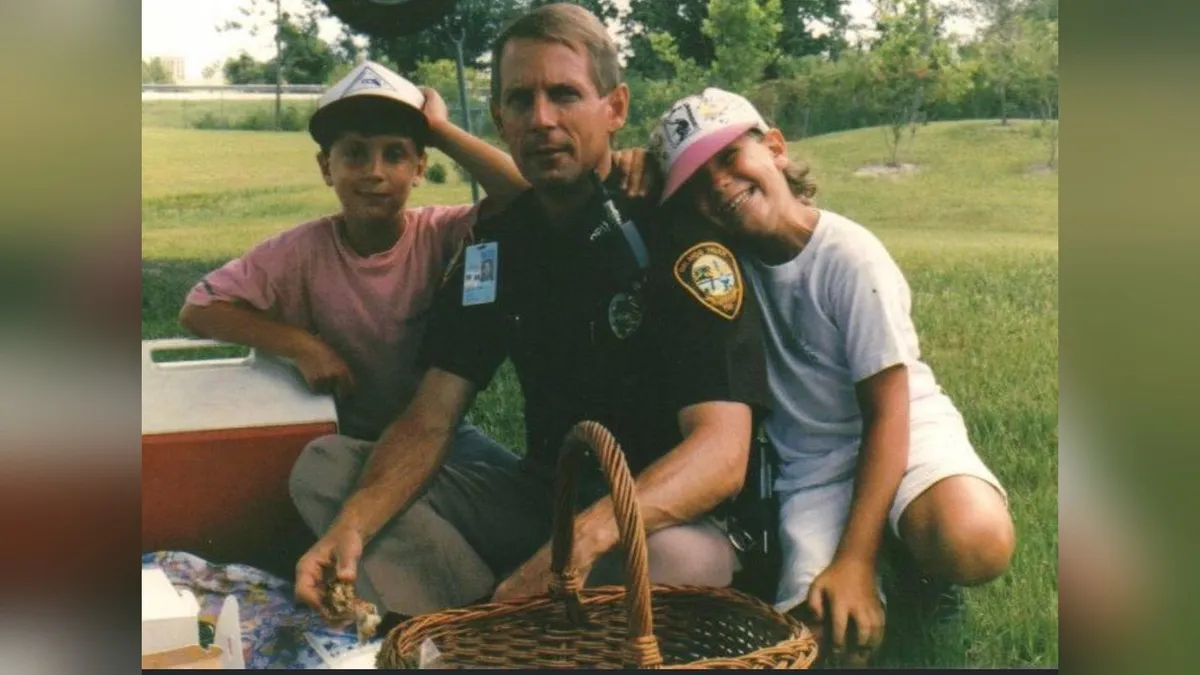 Vintage family photo of a uniformed police officer outdoors with two young boys