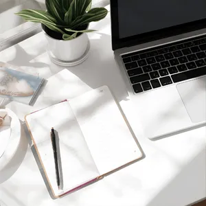 Open notebook with a pen beside a laptop in natural light, a calm setup for booking an intake and jotting down what you want support with