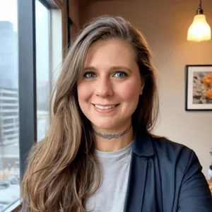 Christine Prebble, licensed professional counselor, smiling in a window-lit office wearing a blazer over a grey shirt, representing Prebble Counseling Services LLC