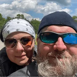 Chris riding with Dan on a motorcycle, capturing the freedom and calm of “wind therapy.”