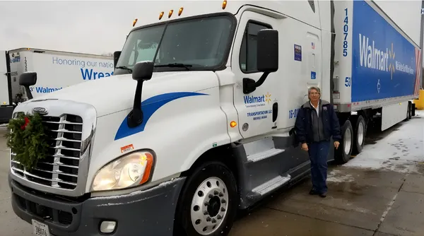Mary, experienced former truck driver, standing next to her Walmart semi during Wreaths Across America transport.