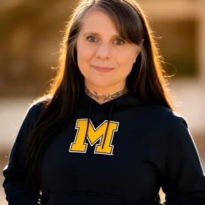 Chris Prebble, Licensed Professional Counselor, wearing a University of Michigan hoodie in a casual outdoor portrait