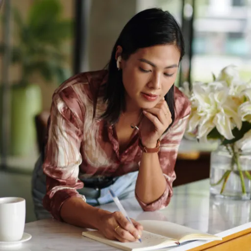 Woman writing in a journal while reflecting on childhood experiences and emotional healing