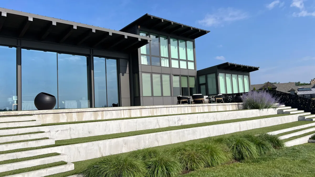 Sleek modern residence with expansive windows and a custom pool area designed to seamlessly integrate with the home's architecture and outdoor living spaces.