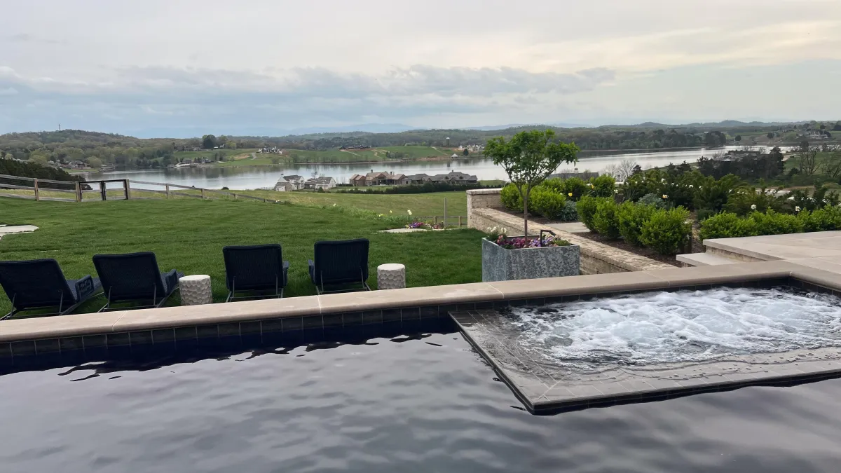 Knife-edge pool design with vanishing waterline overlooking a serene lakefront view in Knoxville, TN.