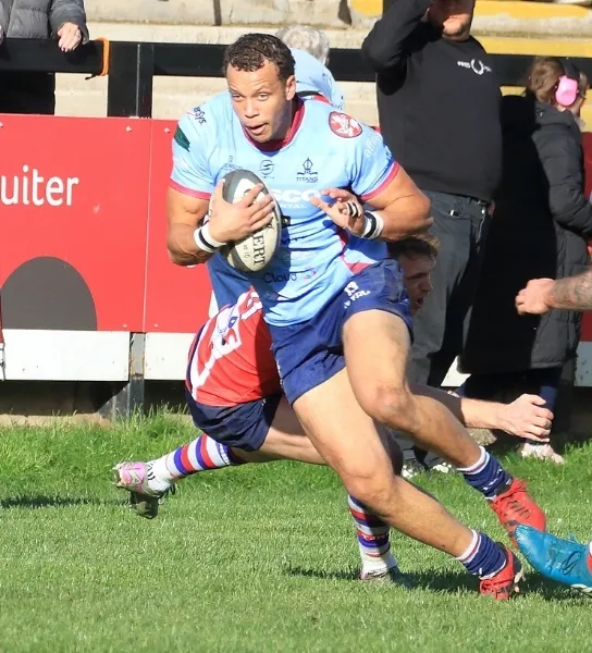 Rotherham Titans player breaking out of a rugby tackle