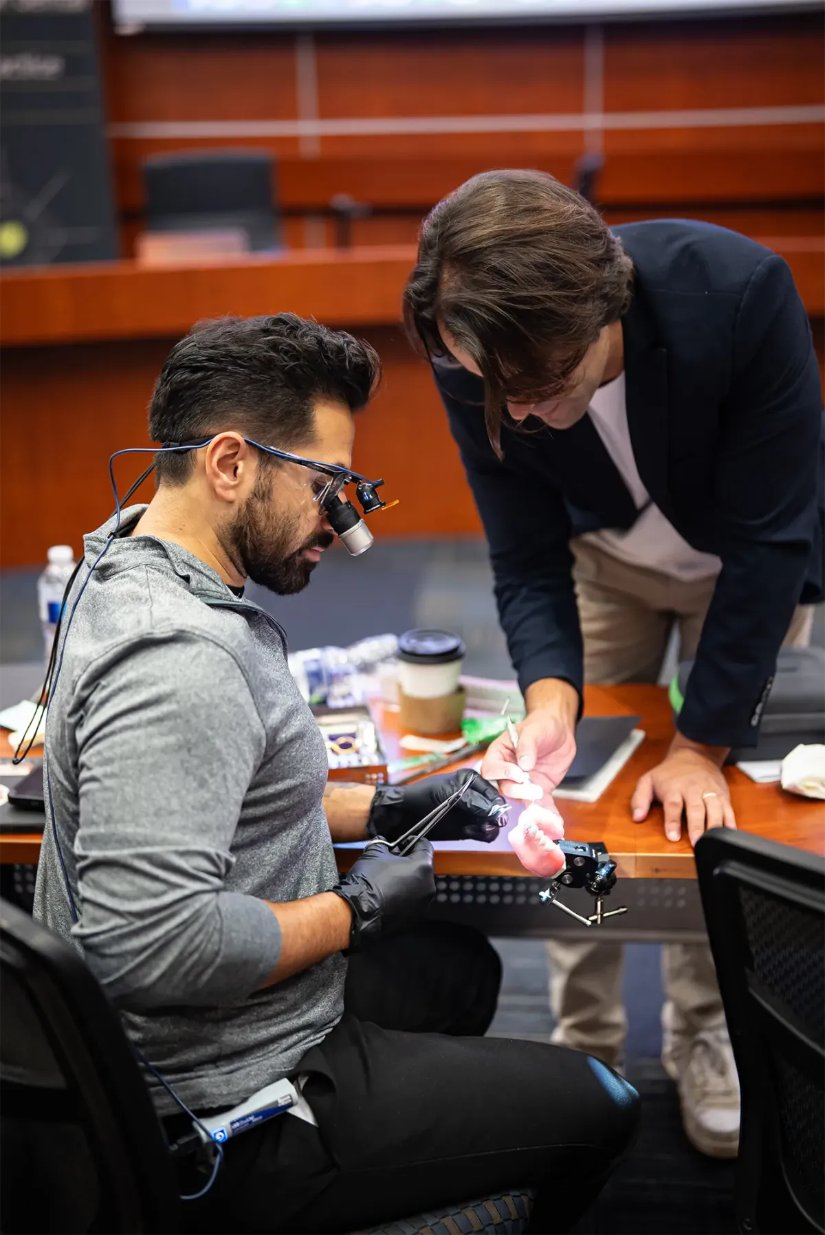 Instructor watches student