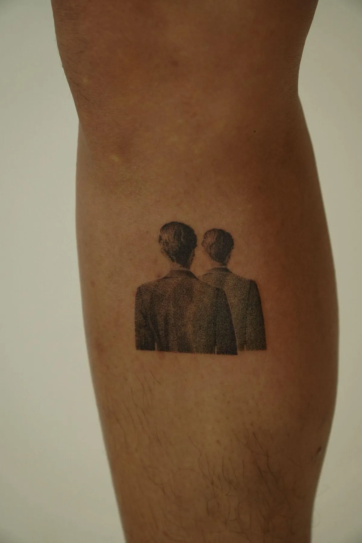 person in blue denim shorts and white nike sneakers standing on gray concrete floor