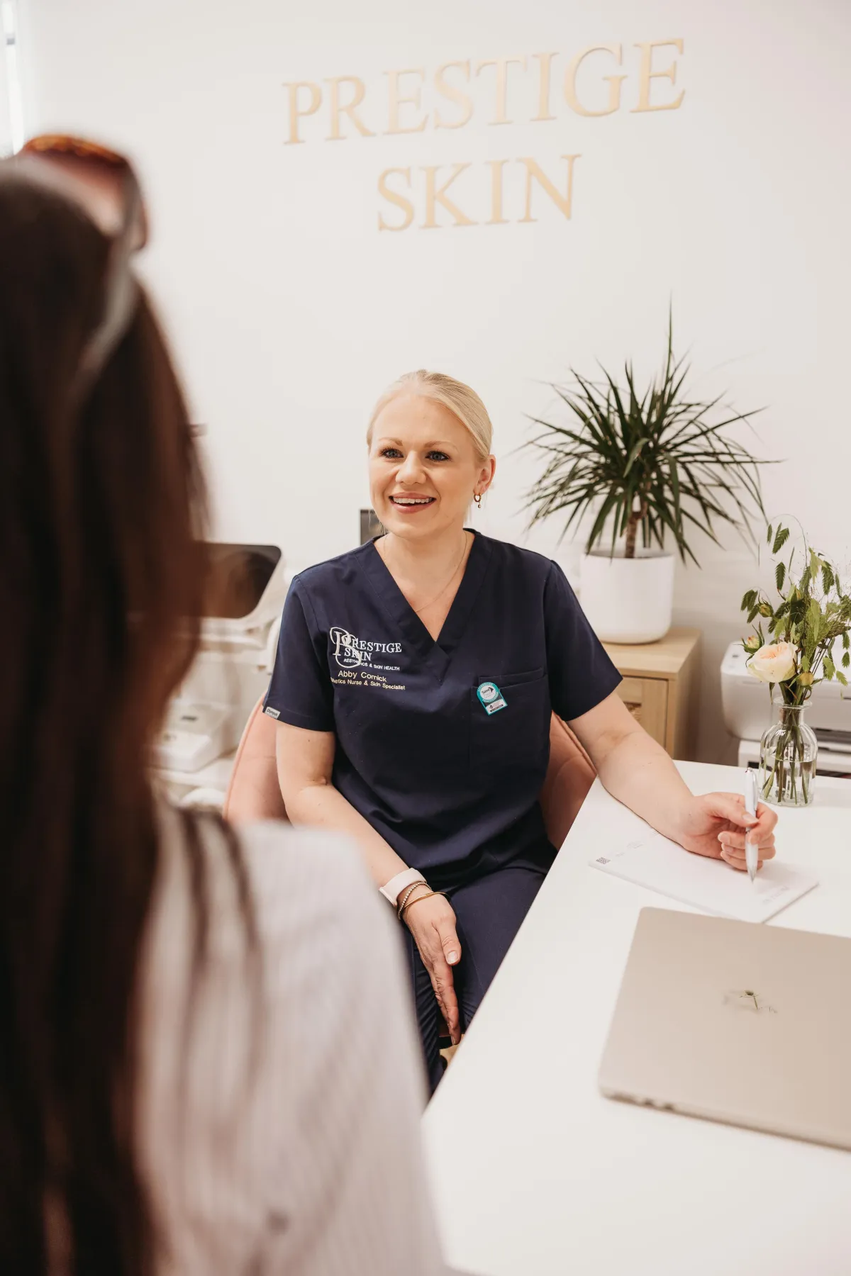 Aesthetic nurse Abby Cornick in conversation with a client during a personalised skin consultation at Prestige Skin, Cambridge