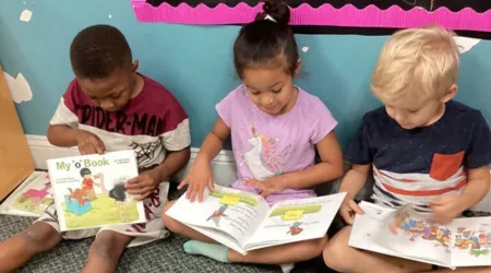 Boys and girl reading books in classroo