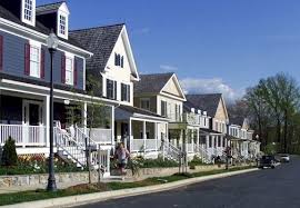 Row of suburban homes with front porches along a quiet residential street.