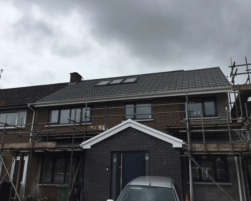 A tiled roof with three Velux windows that our roofing company worked on.