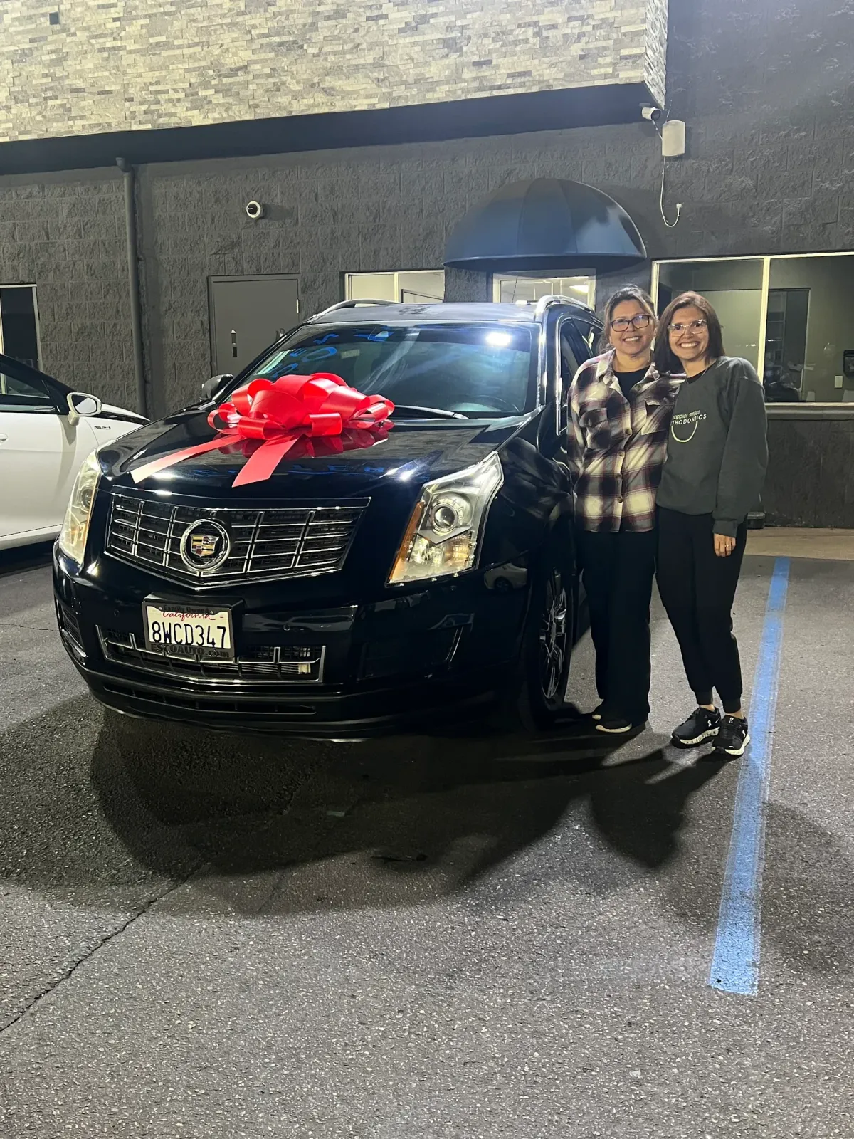 Customer receiving keys for a performance sedan