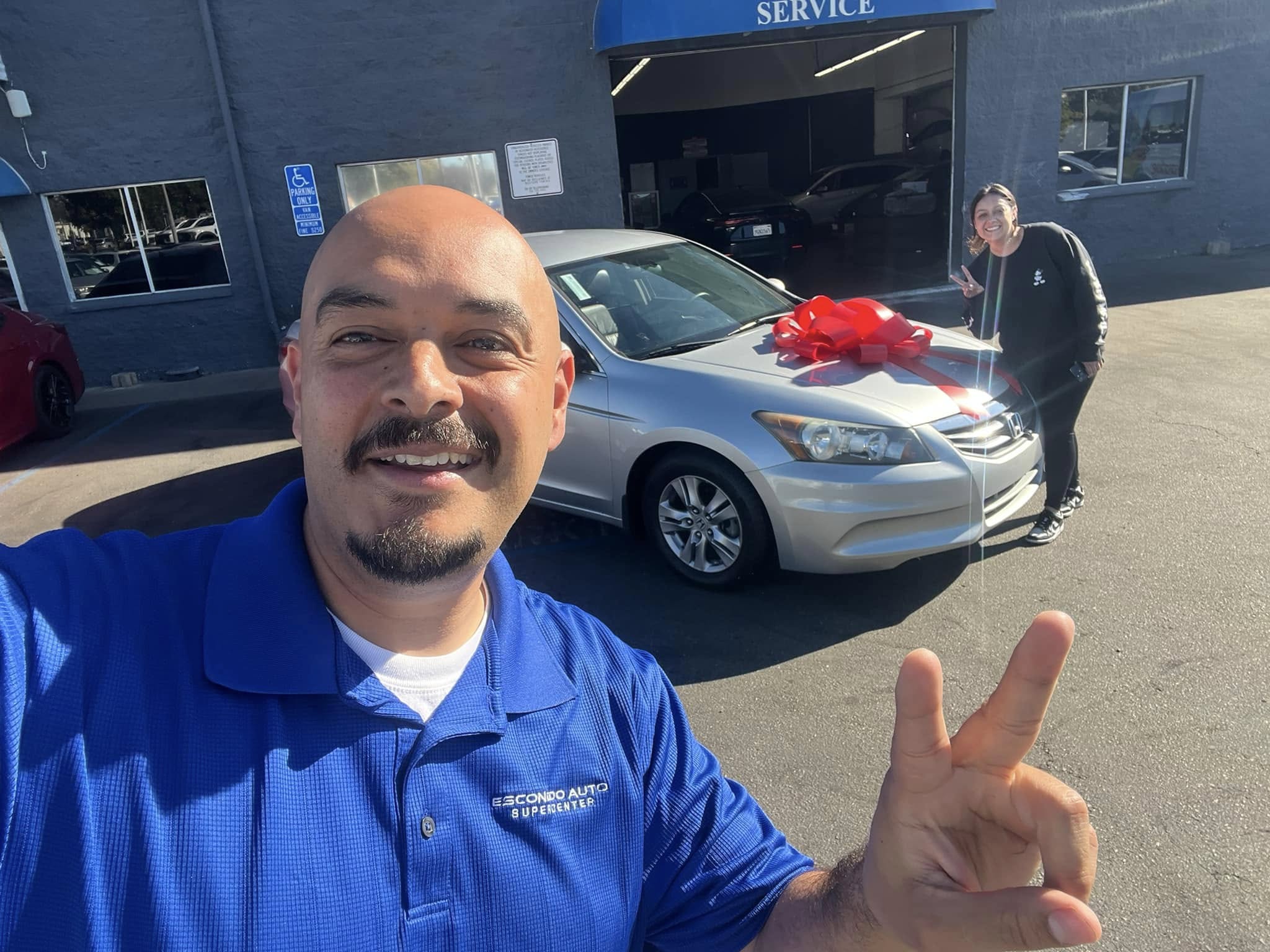 Customer receiving keys for a performance sedan