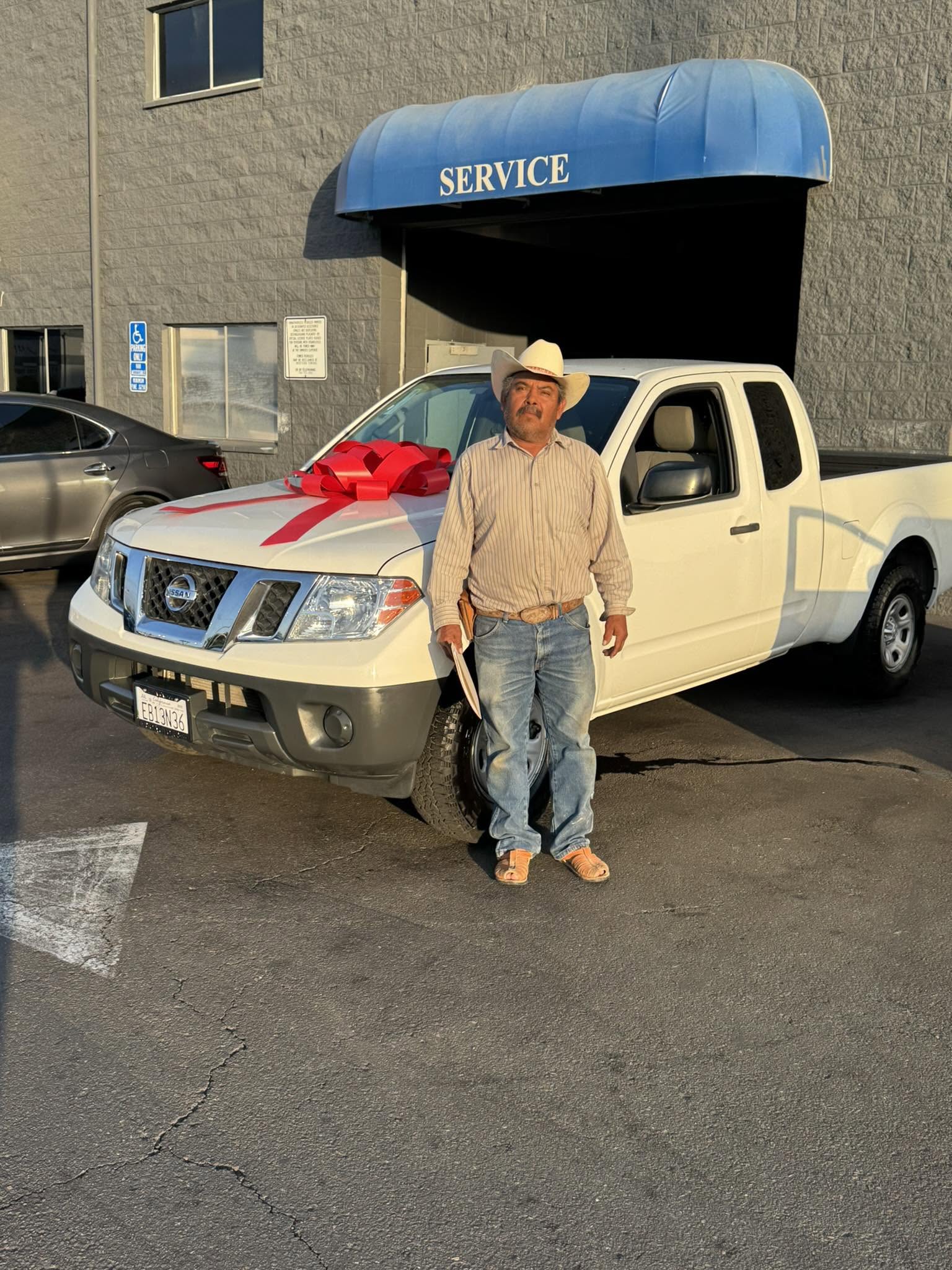 Couple celebrating next to a pre-owned truck