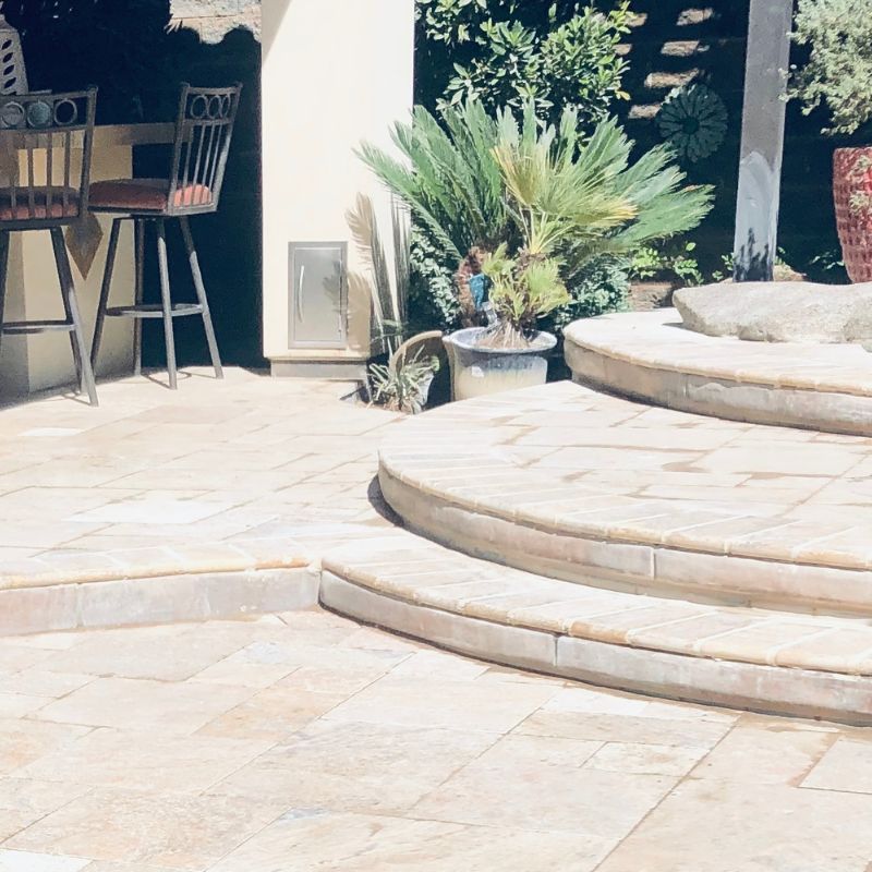 Custom masonry steps and staircase connecting multi-level backyard landscape in Wake County