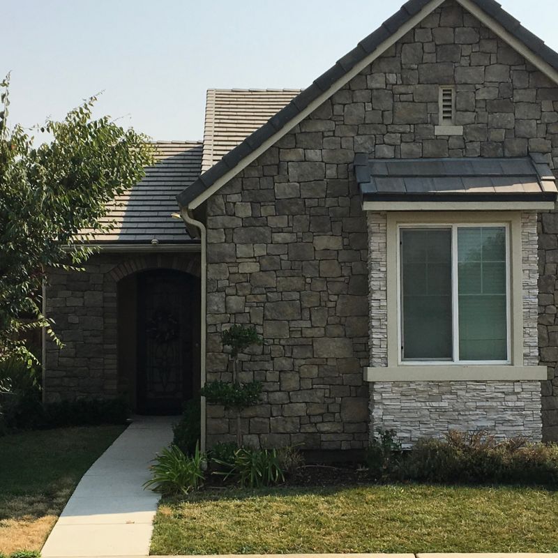 Natural stone veneer siding installation transforming home exterior by 1OAK masonry contractor Raleigh