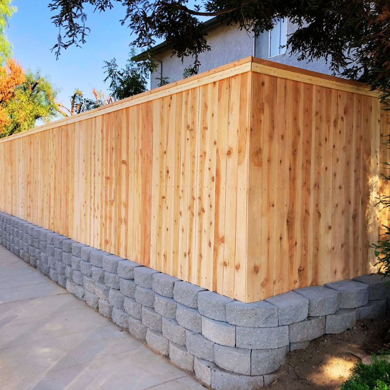 Custom stone retaining wall built by 1OAK creating tiered landscape levels in Raleigh NC backyard