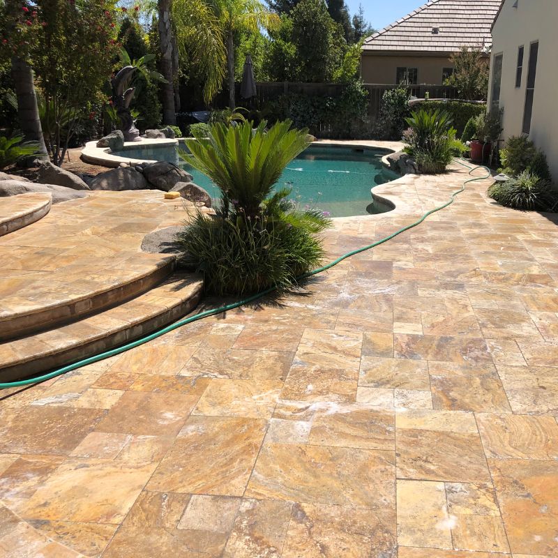 Slip-resistant paver pool deck and surround installation around backyard swimming pool in Raleigh