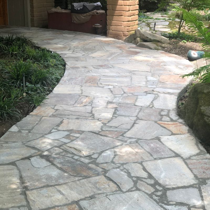 Natural flagstone patio with irregular stone pattern creating organic outdoor living space in NC