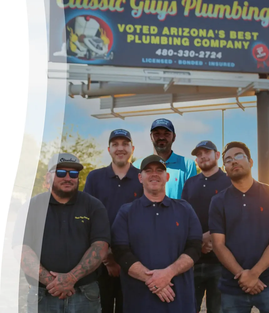 The Classic Guys Plumbing team standing in front of a billboard that reads “Voted Arizona’s Best Plumbing Company,” showcasing their trusted, licensed local service.