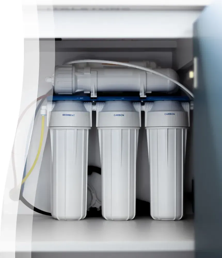 Under-sink reverse osmosis water filtration system with sediment and carbon filters installed in an Arizona home.