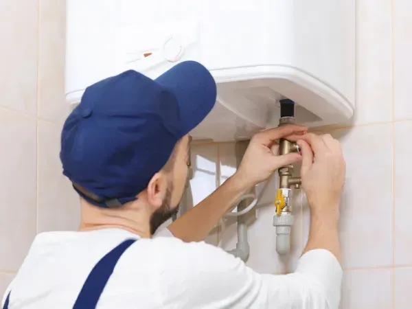 Technician repairing a tankless water heater in Arizona