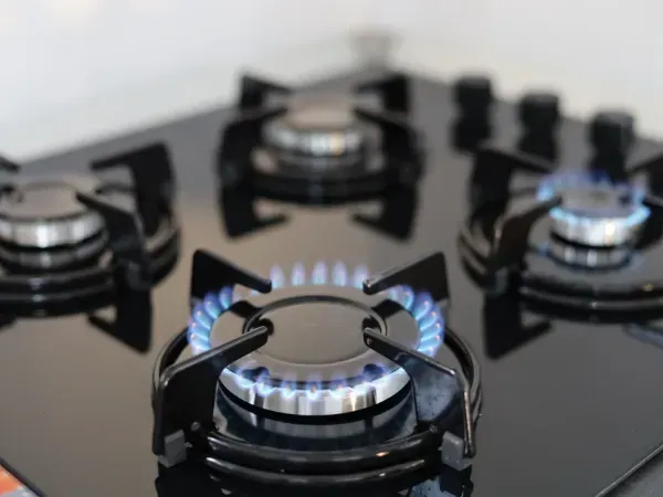 Modern kitchen natural gas stove with burners turned on