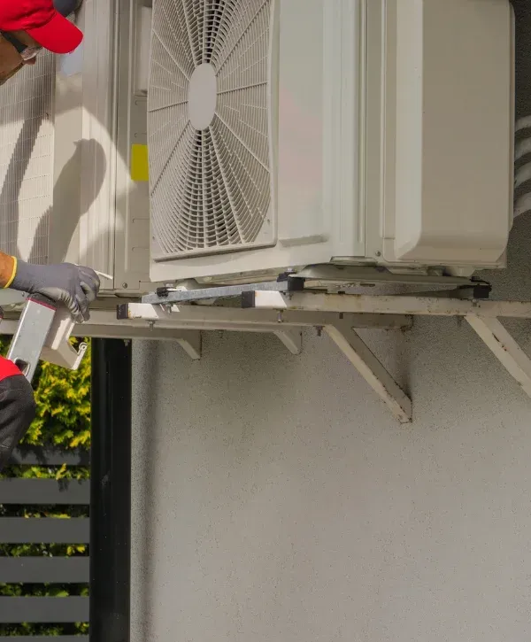 HVAC technician servicing outdoor air conditioning unit