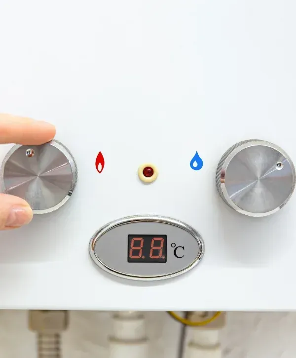 Close-up of water heater temperature control knobs and digital display.