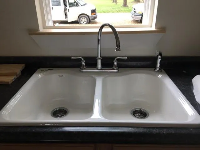 Dual kitchen sink installation with modern fixtures