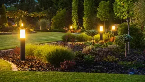Landscape lighting installation with illuminated garden pathways by Sunnyvale Landscaping Pro