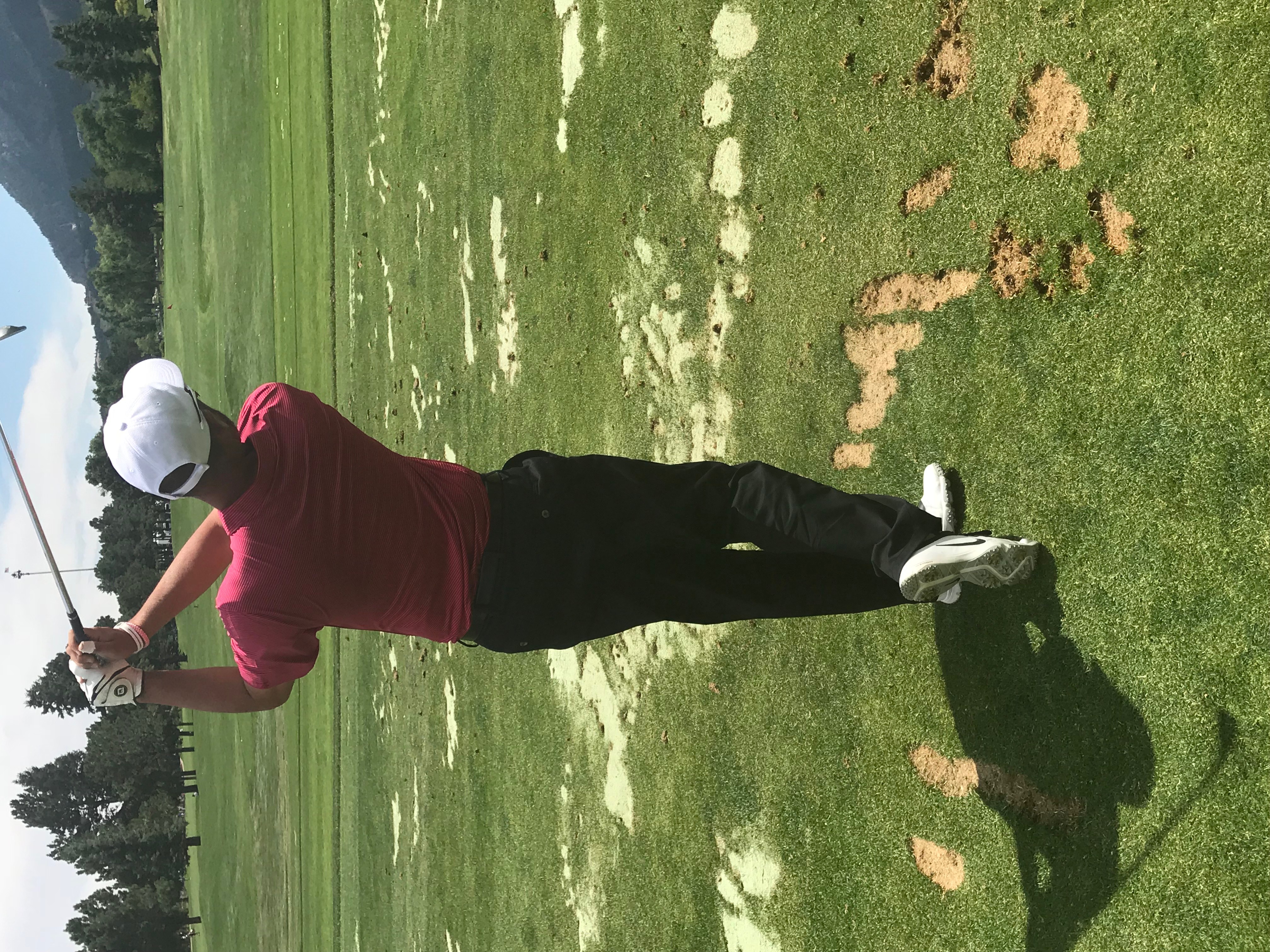 Scott Pieri demonstrating a powerful golf swing on a lush green course, early morning light, wearing modern golf attire, focused expression, background of rolling fairways and distant trees, dynamic action shot, 3:2 aspect ratio.