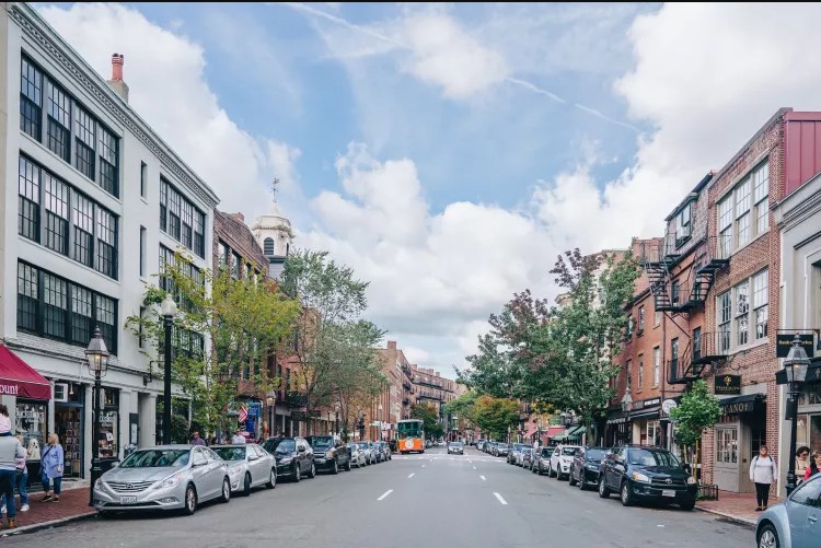 white and brown houses near body of water during daytime