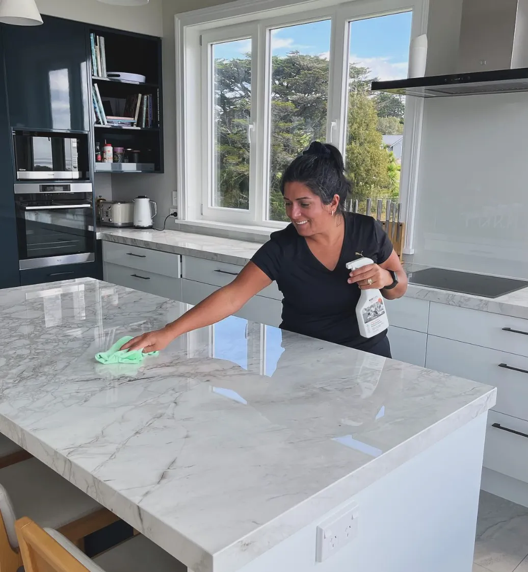 Professional cleaner using eco-friendly products in Auckland office