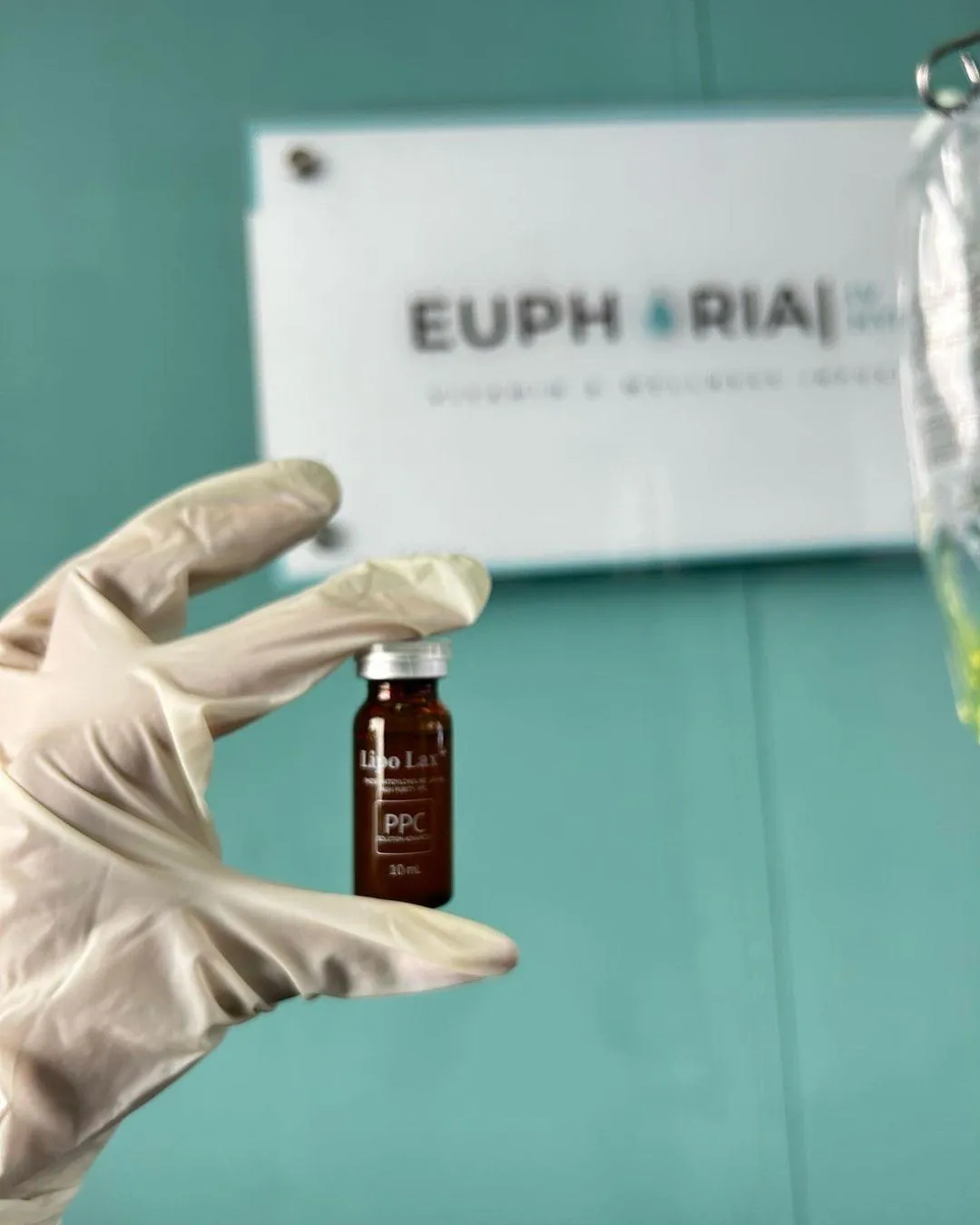 person holds plastic bottle