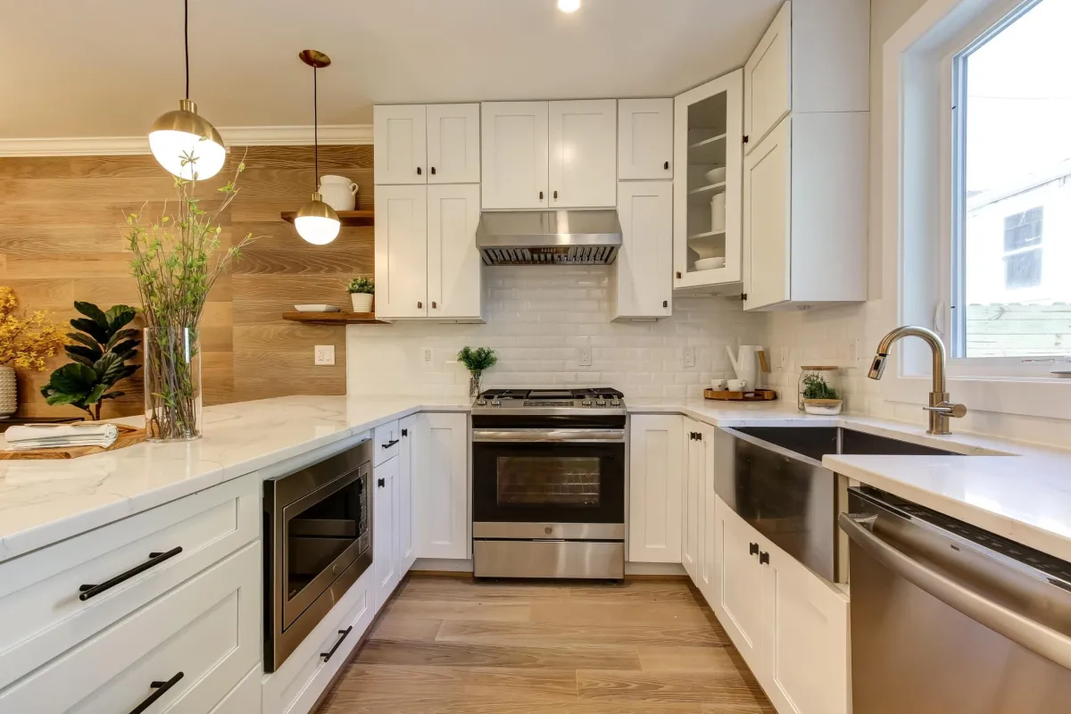 a kitchen with white cabinets and white counter tops