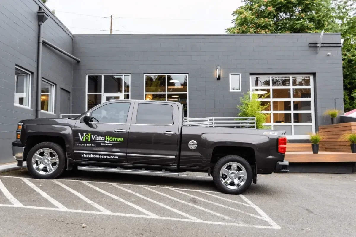 a black truck parked in front of a building