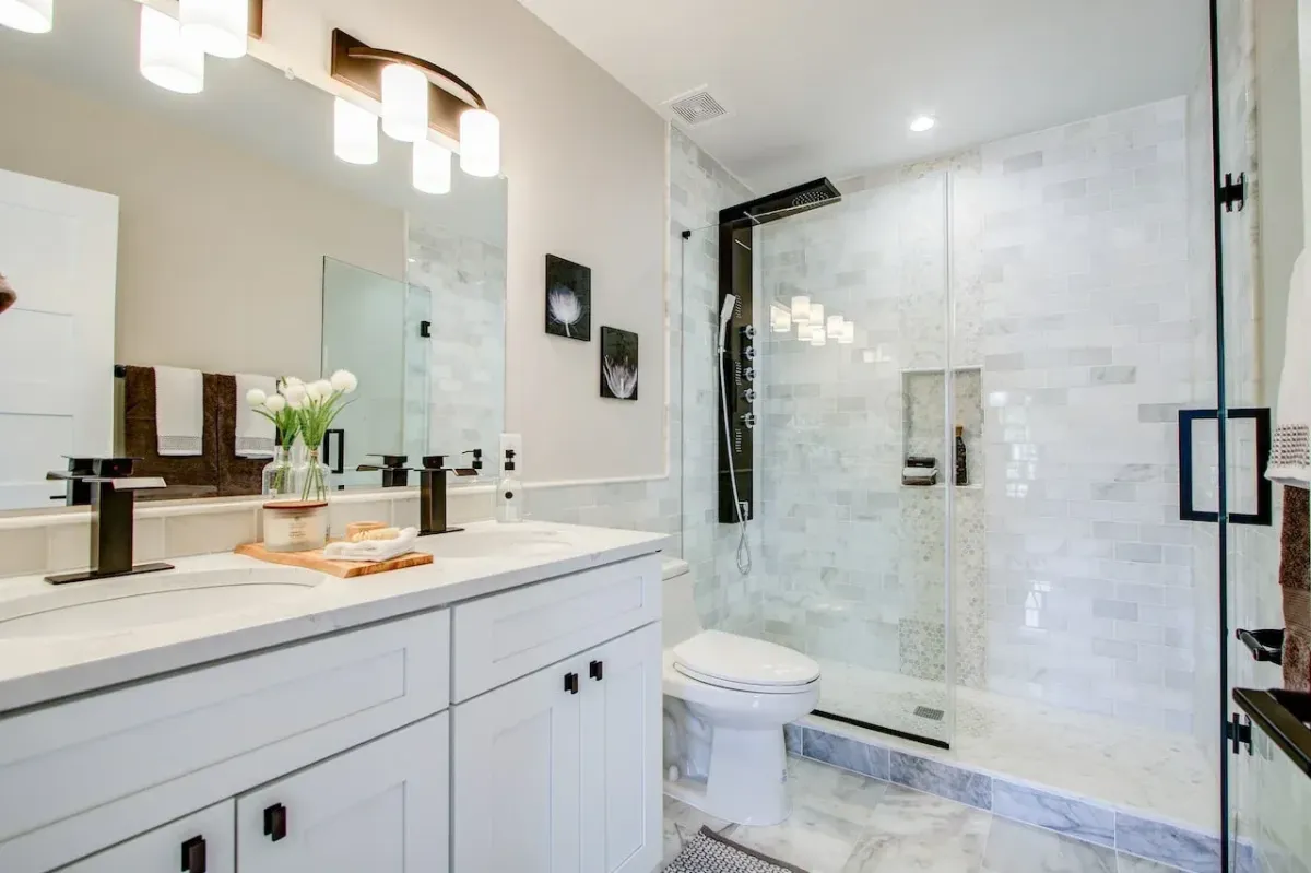 a bathroom with a glass shower and sink