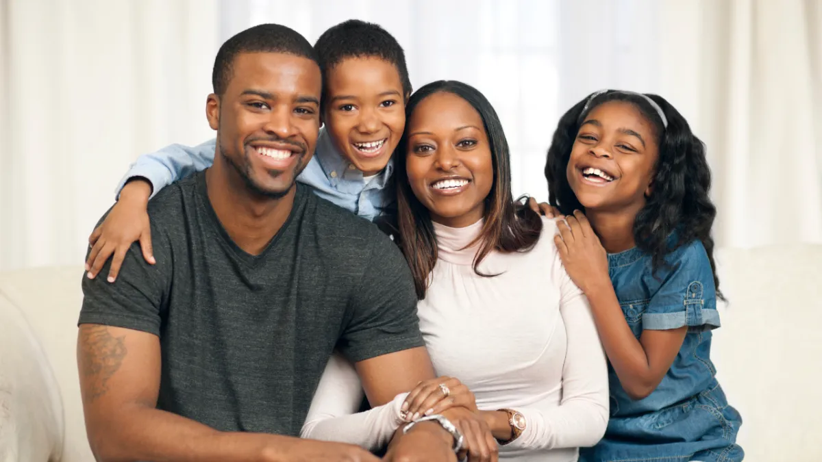 a person speaking into a microphone in front of a group of people
