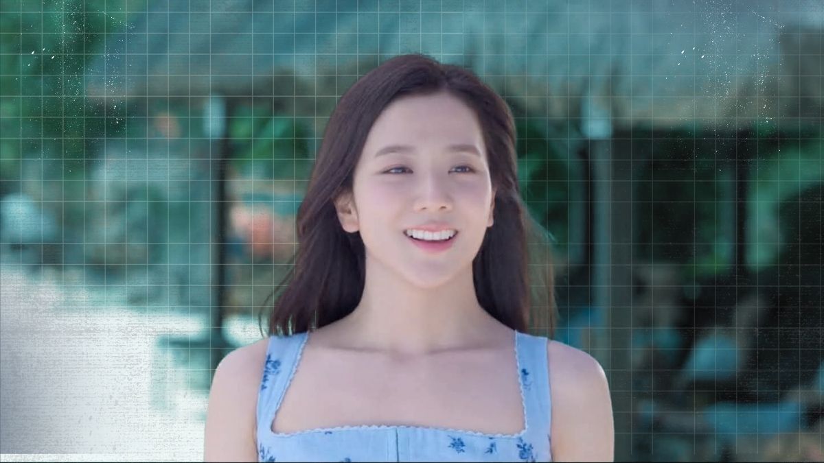 Jisoo standing on a tropical beach with clear water and white sand during a drama filming scene.