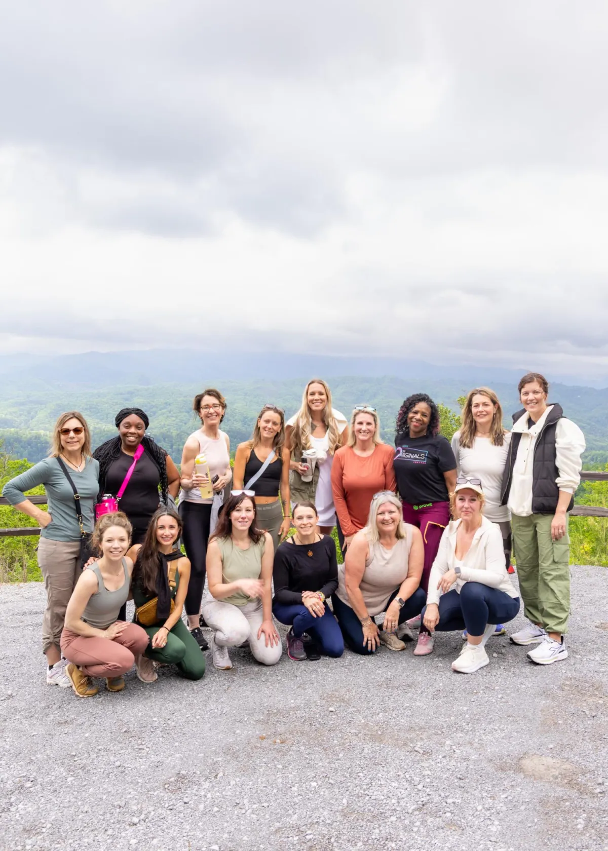 This image shows a cheerful woman wearing headphones, sitting at a desk and enthusiastically interacting with her laptop, suggesting she's engaged in a video call or virtual coaching session. Her setting includes a bright room with plants in the background, giving a fresh and motivating atmosphere.