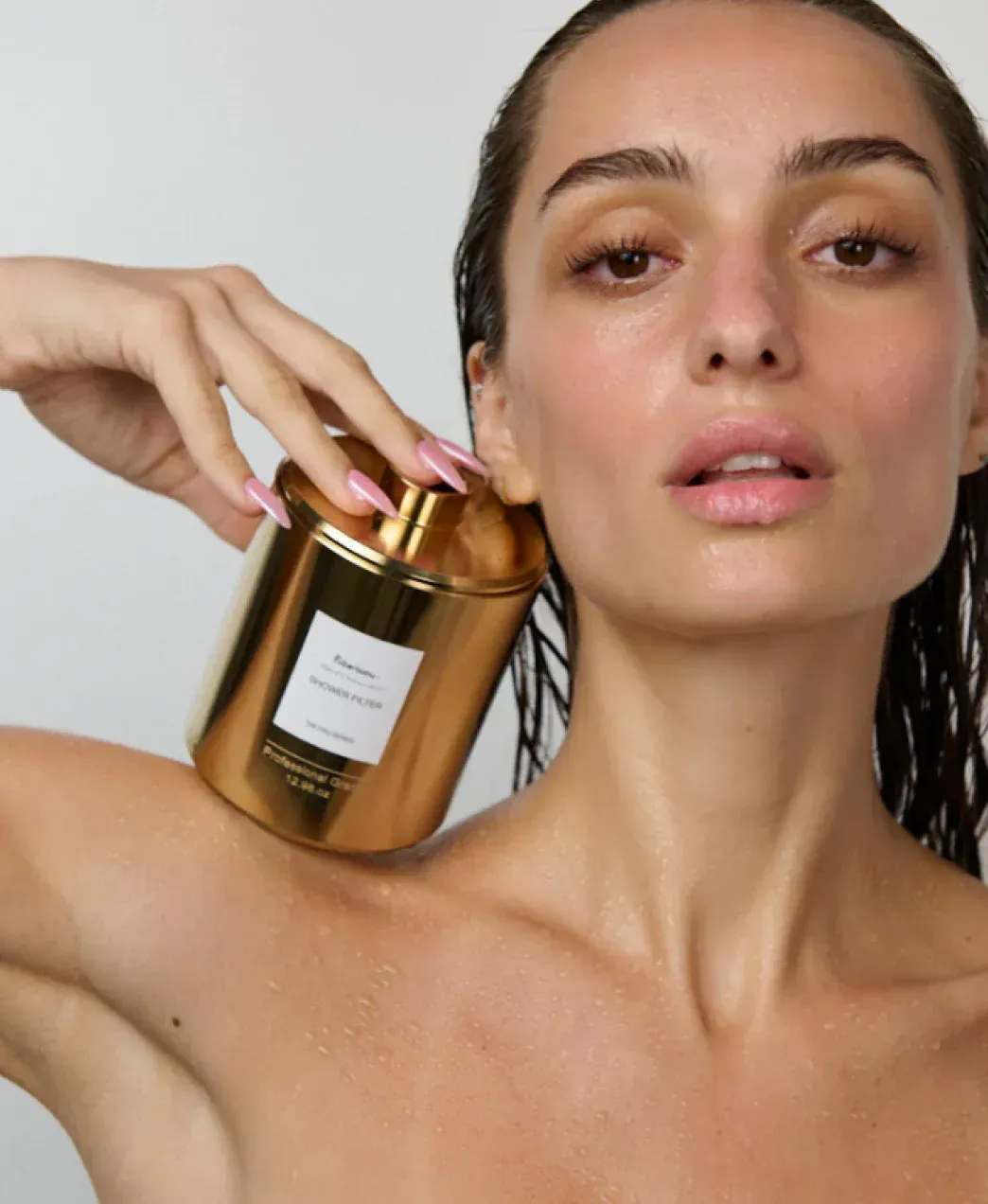 Hard water hair damage — shower products in green-tiled shower | Hair Care Guide