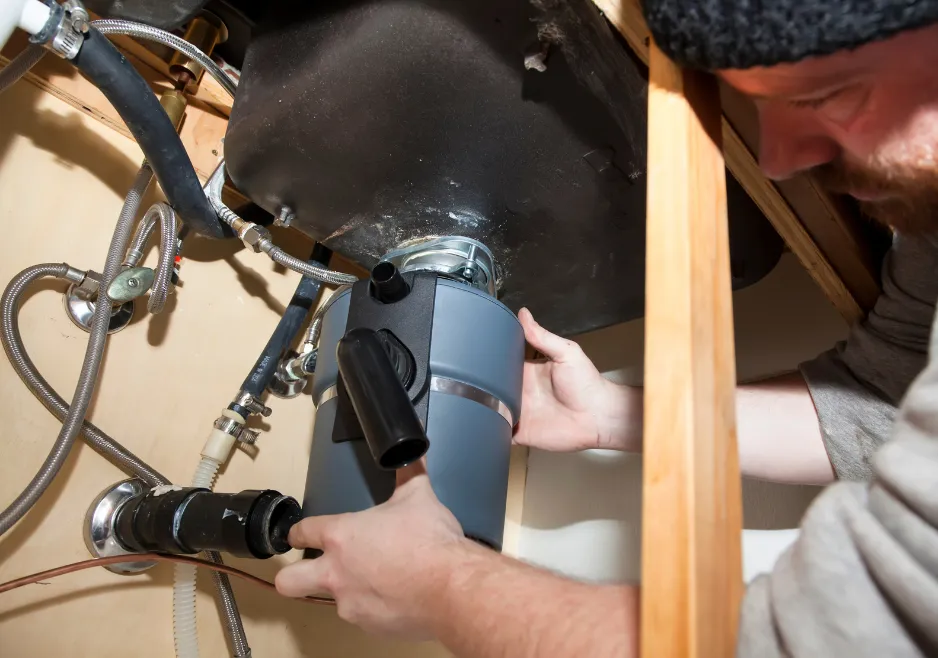Plumber installing a faucet and checking its water connections